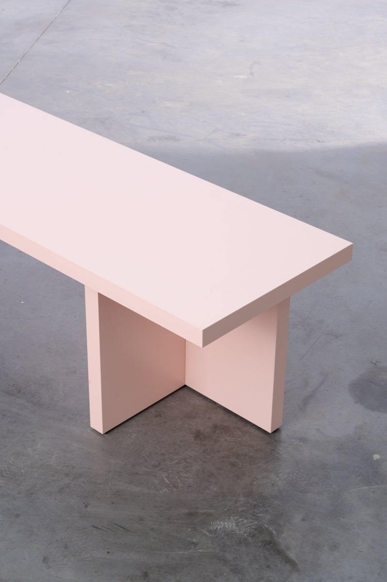 Pink wooden bench by Bobbie Bahama in sleek design