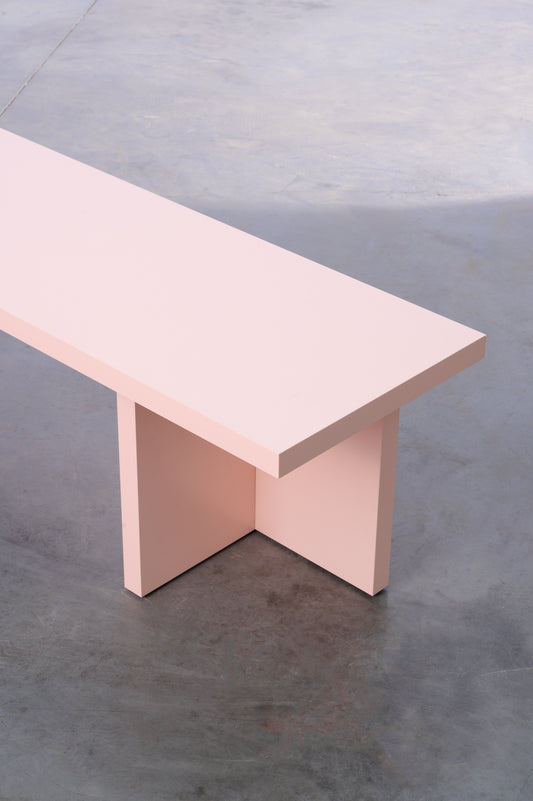Pink wooden bench in sleek design by Bobbie Bahama
