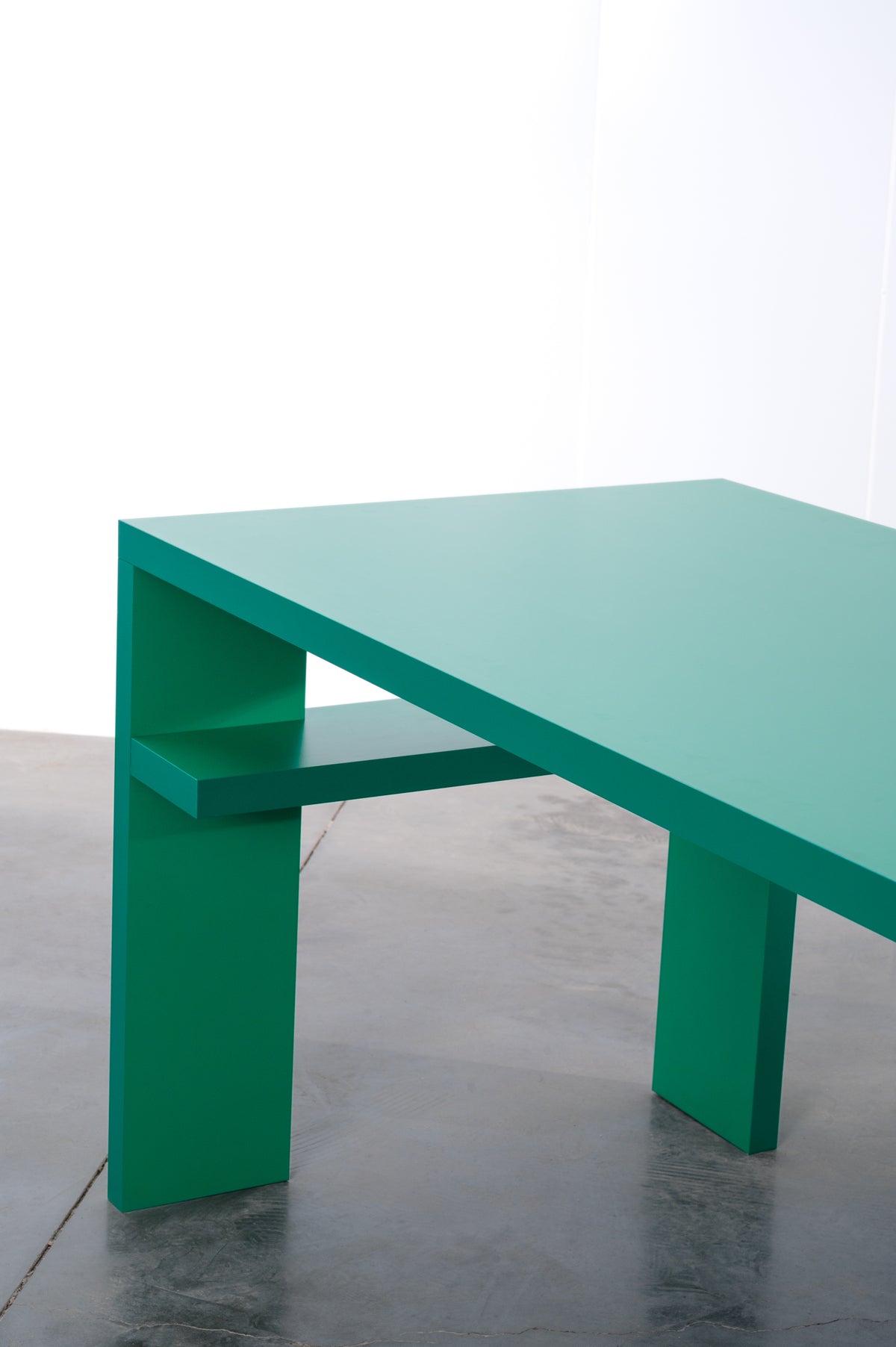 Side profile of bright green wooden desk by Bobbie Bahama