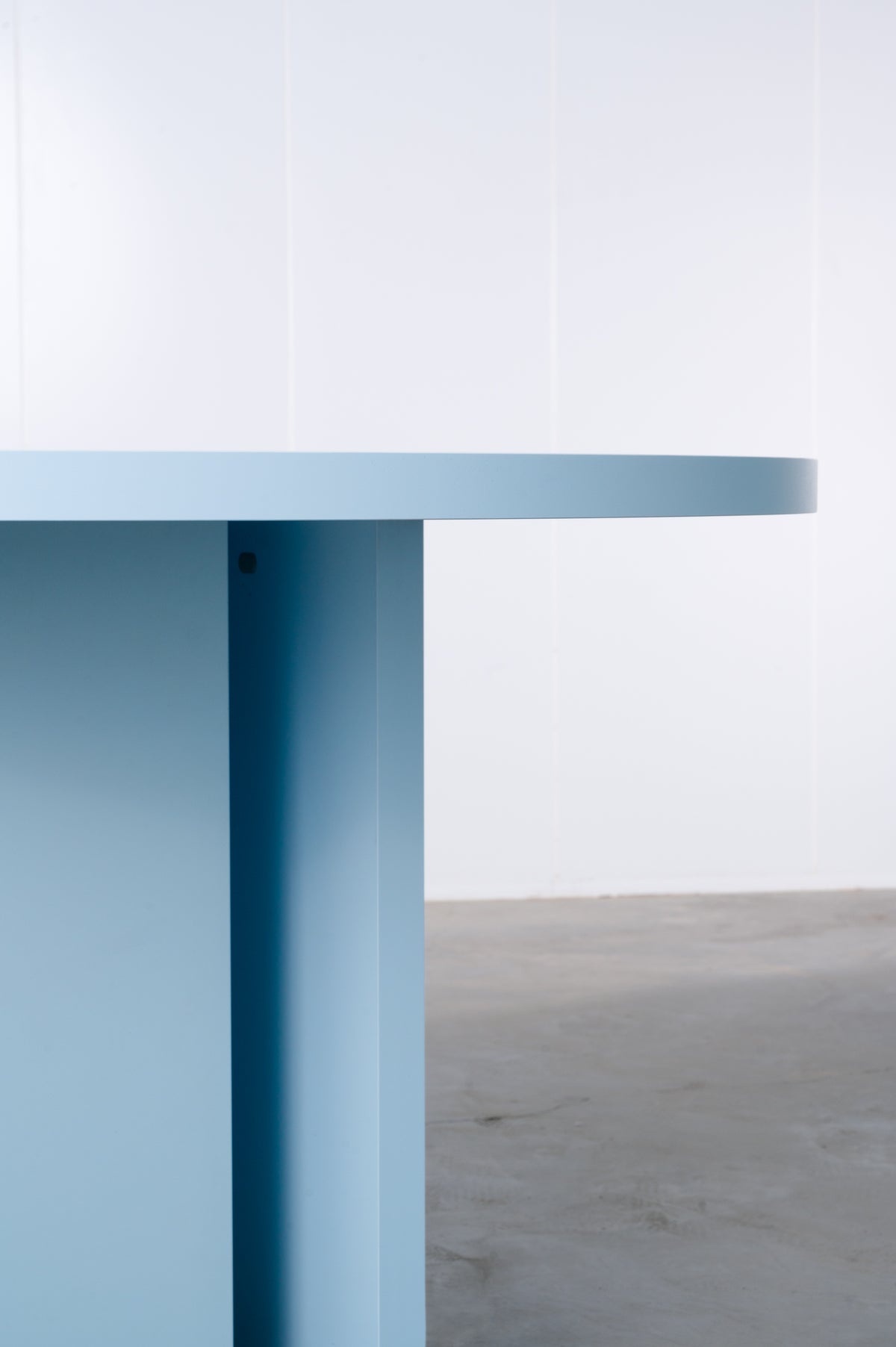 Detail of baby blue wooden round table designed by Bobbie Bahama