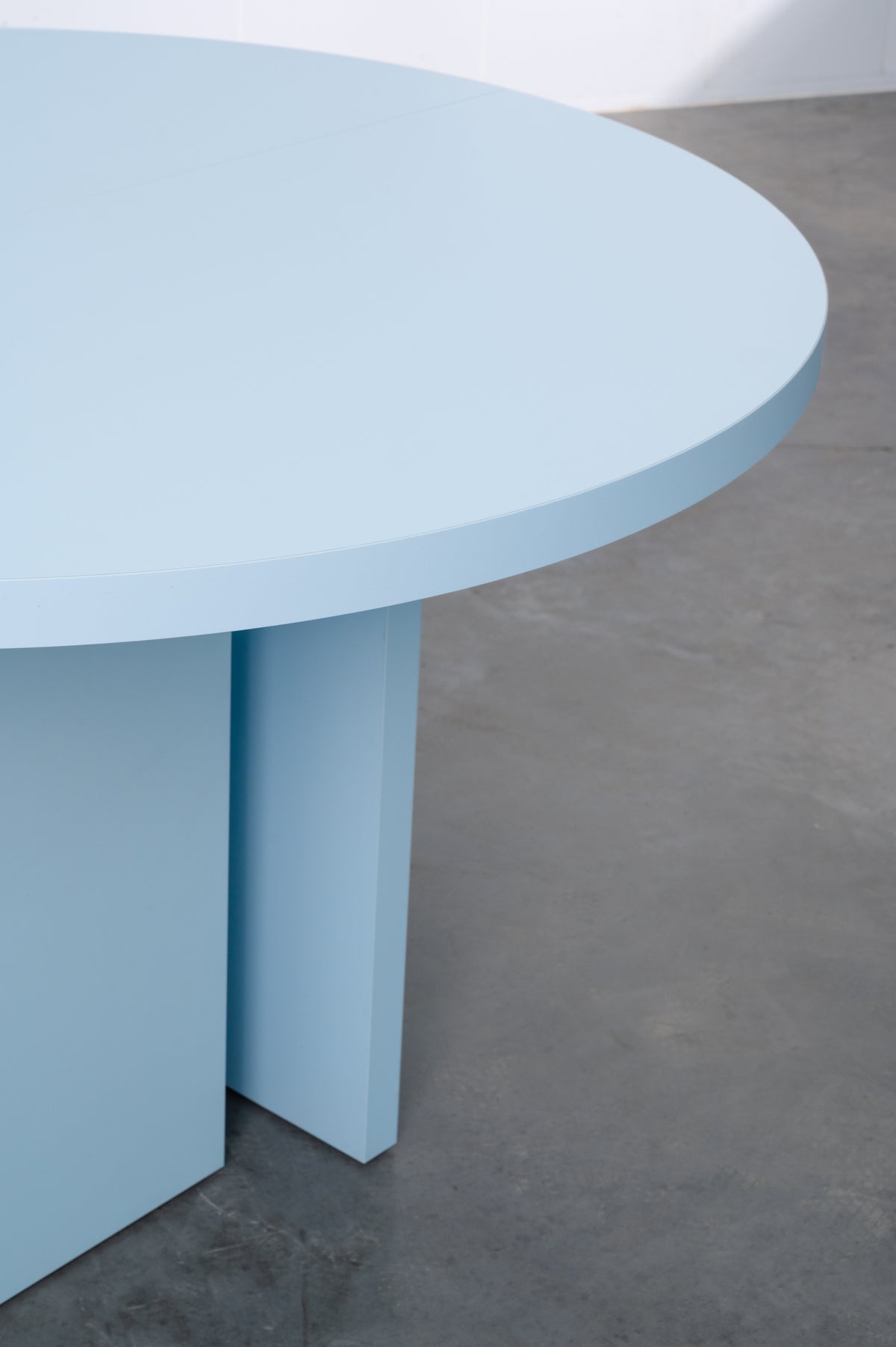 Baby blue wooden round table designed by Bobbie Bahama