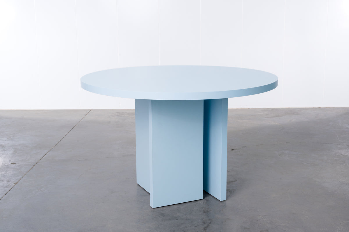 Baby blue wooden round table designed by Bobbie Bahama
