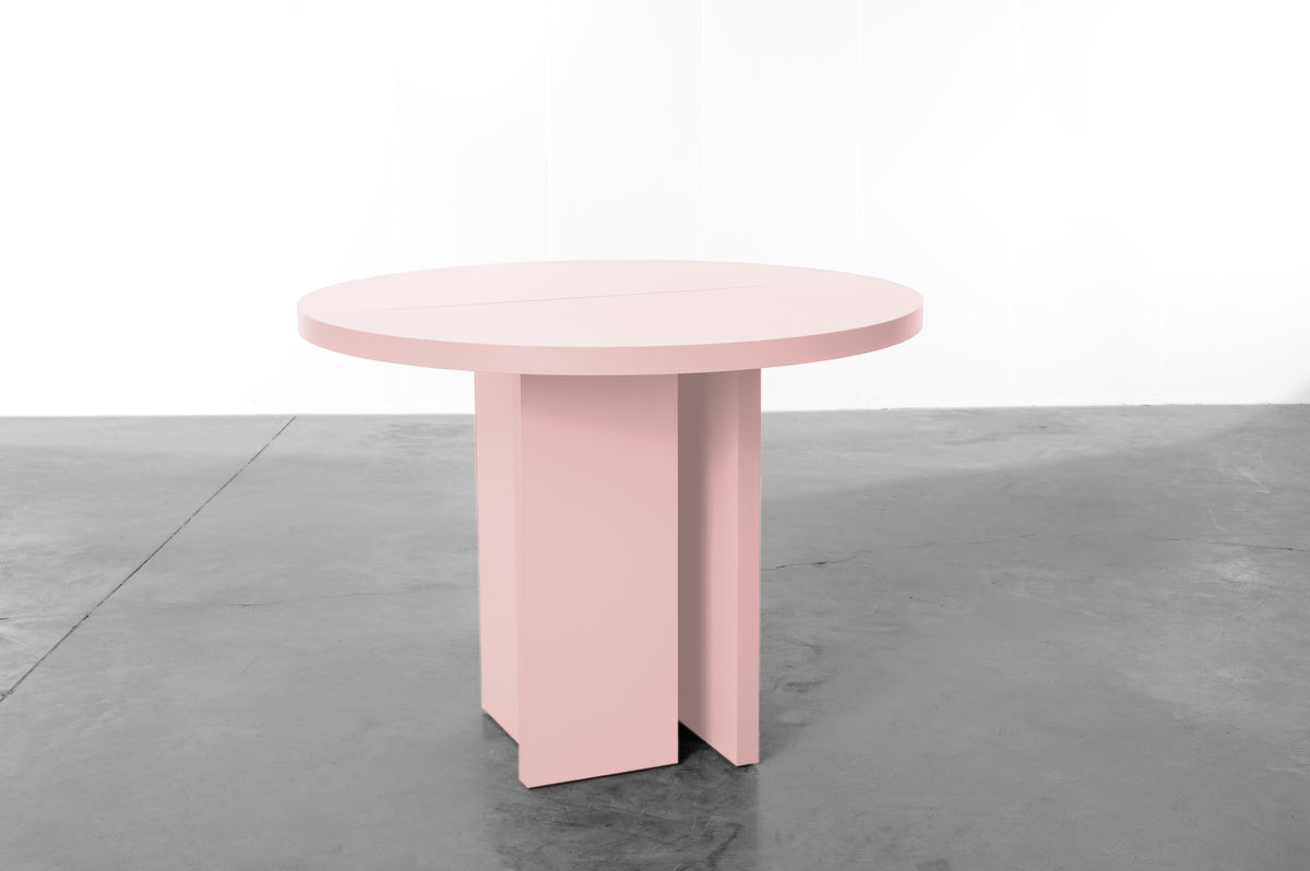 Baby pink wooden round table designed by Bobbie Bahama