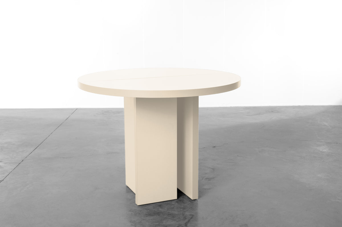 Ecru wooden round table designed by Bobbie Bahama