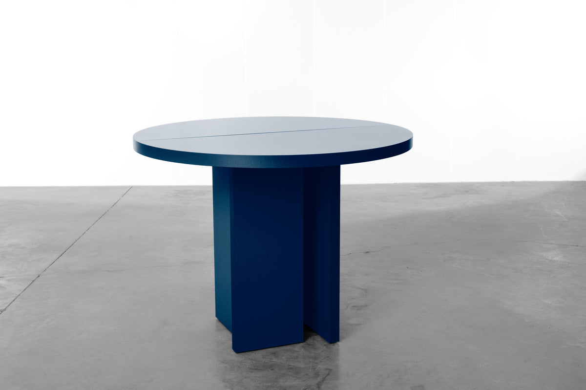 Dark blue wooden round table designed by Bobbie Bahama