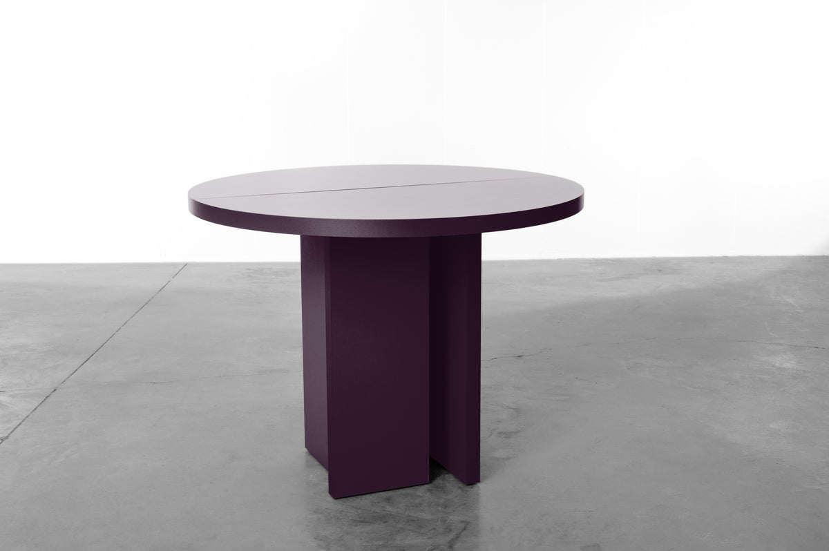 Deep plum round table designed by Bobbie Bahama