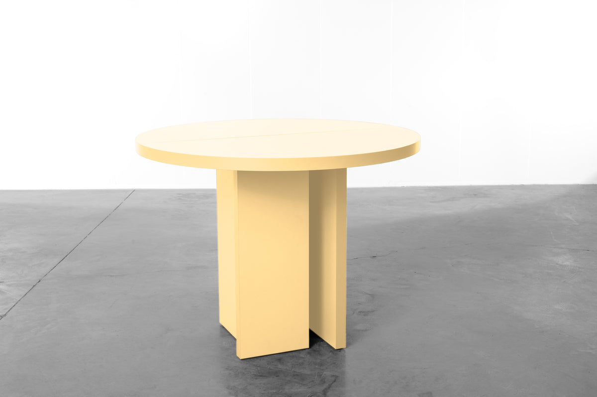 Butter yellow wooden round table designed by Bobbie Bahama