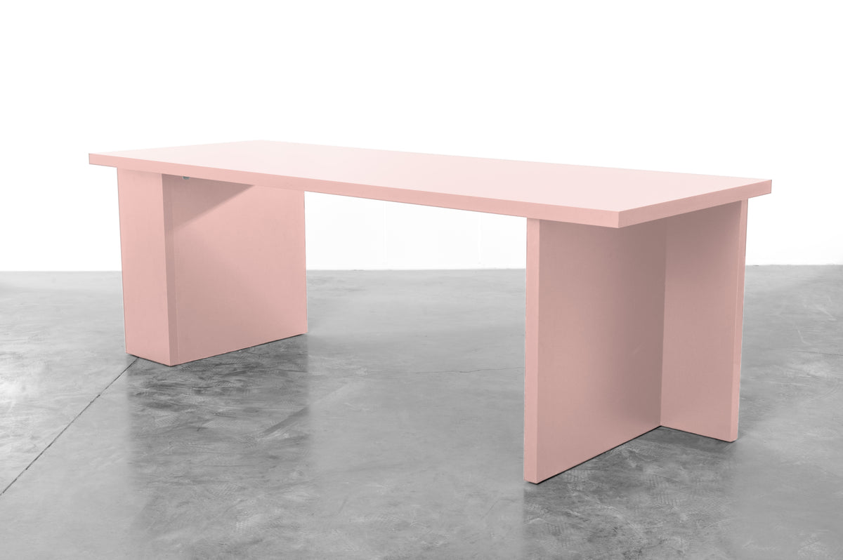 Large rectangular wooden dining table in baby pink designed by Bobbie Bahama