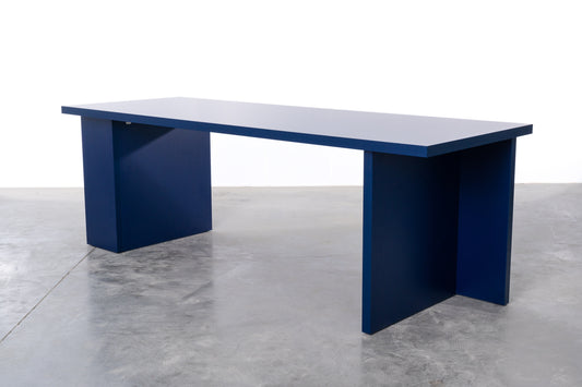 Large rectangular wooden dining table in deep dark blue designed by Bobbie Bahama