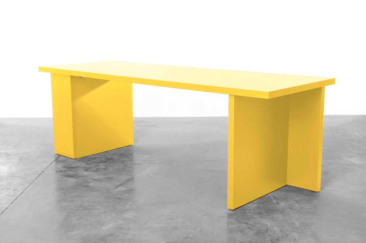 Large rectangular wooden dining table in bright yellow designed by Bobbie Bahama