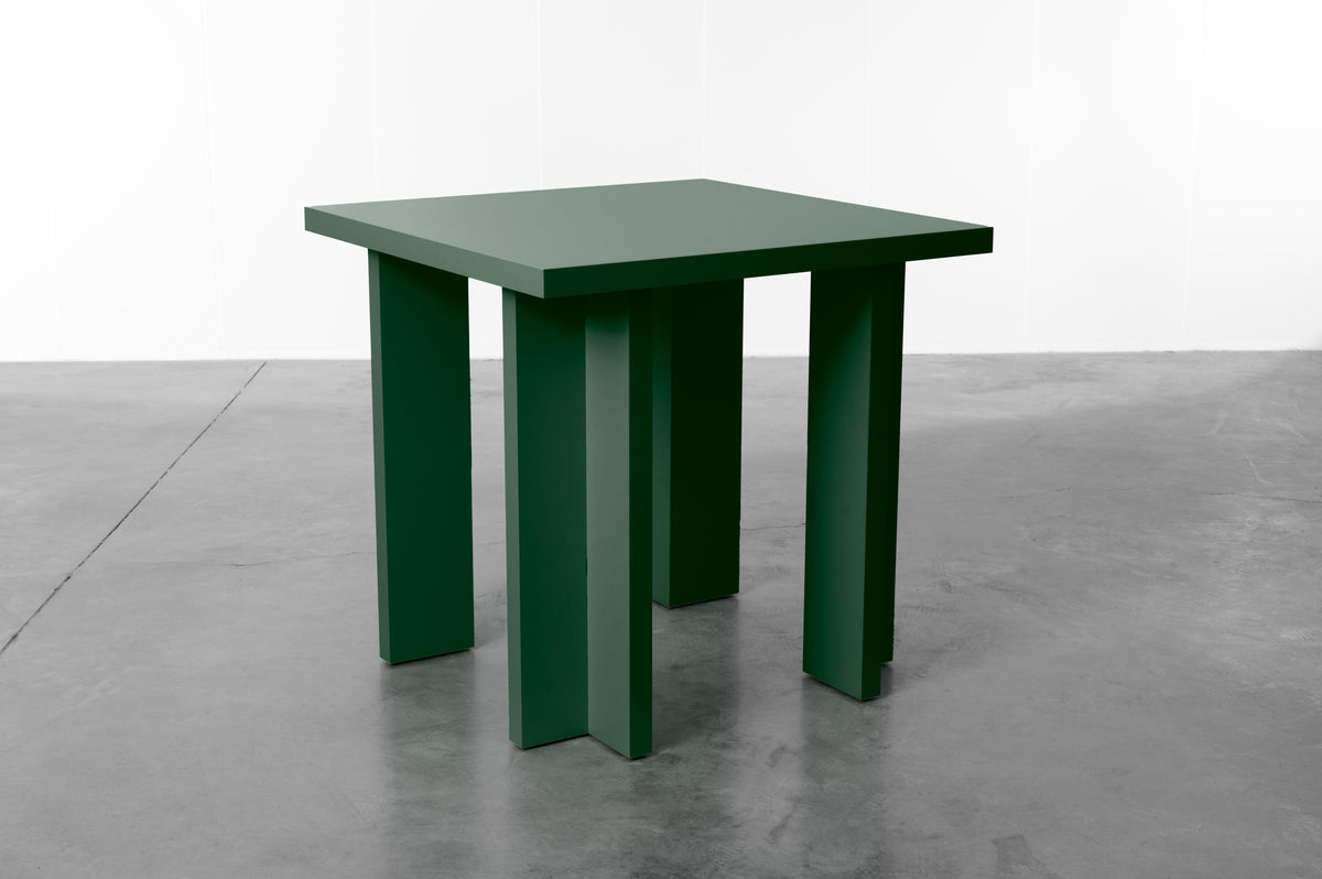 Rectangular wooden dining table in dark moss green designed by Bobbie Bahama