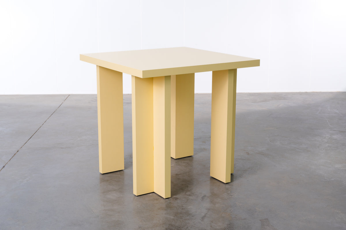 Rectangular wooden dining table in butter yellow designed by Bobbie Bahama